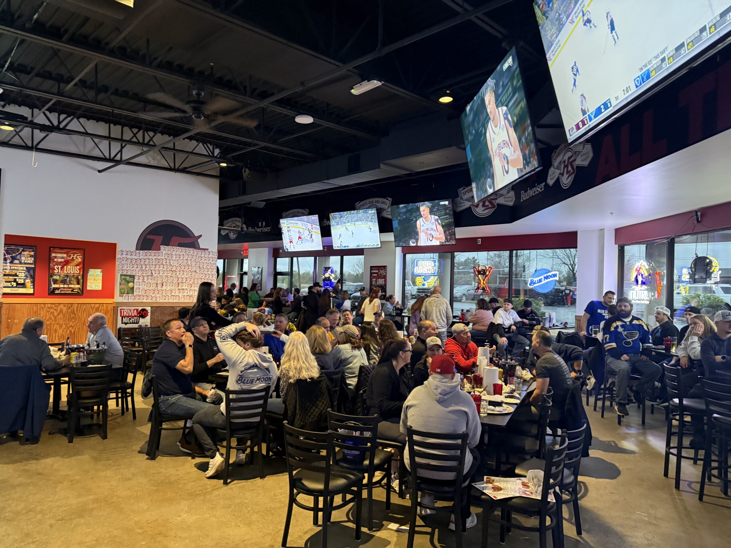 Guests watching sports inside a Hotshots Sports Bar & Grill location.